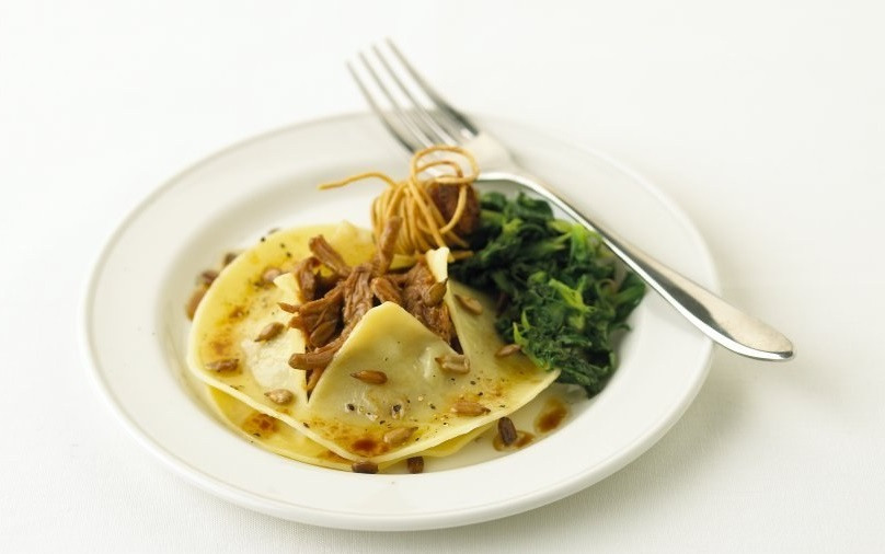 Open Confit of Duck Ravioli on Lambs Lettuce Foie Gras Bonbon Lemon Oil Pine Kernal Dressing JPEG Banner